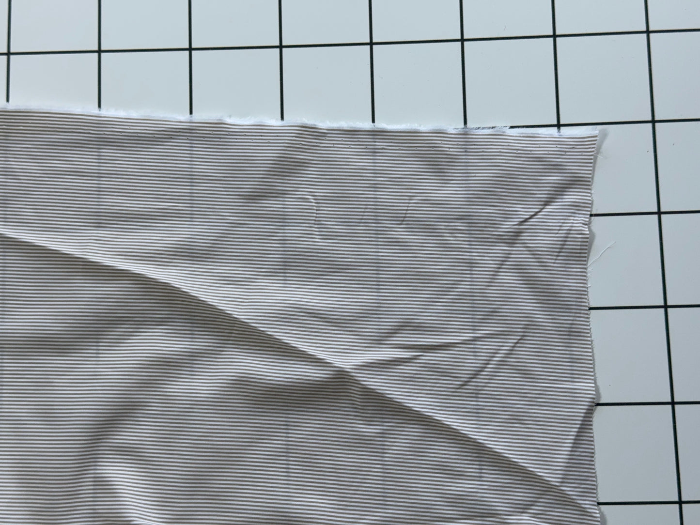 Striped fabric on a grid background