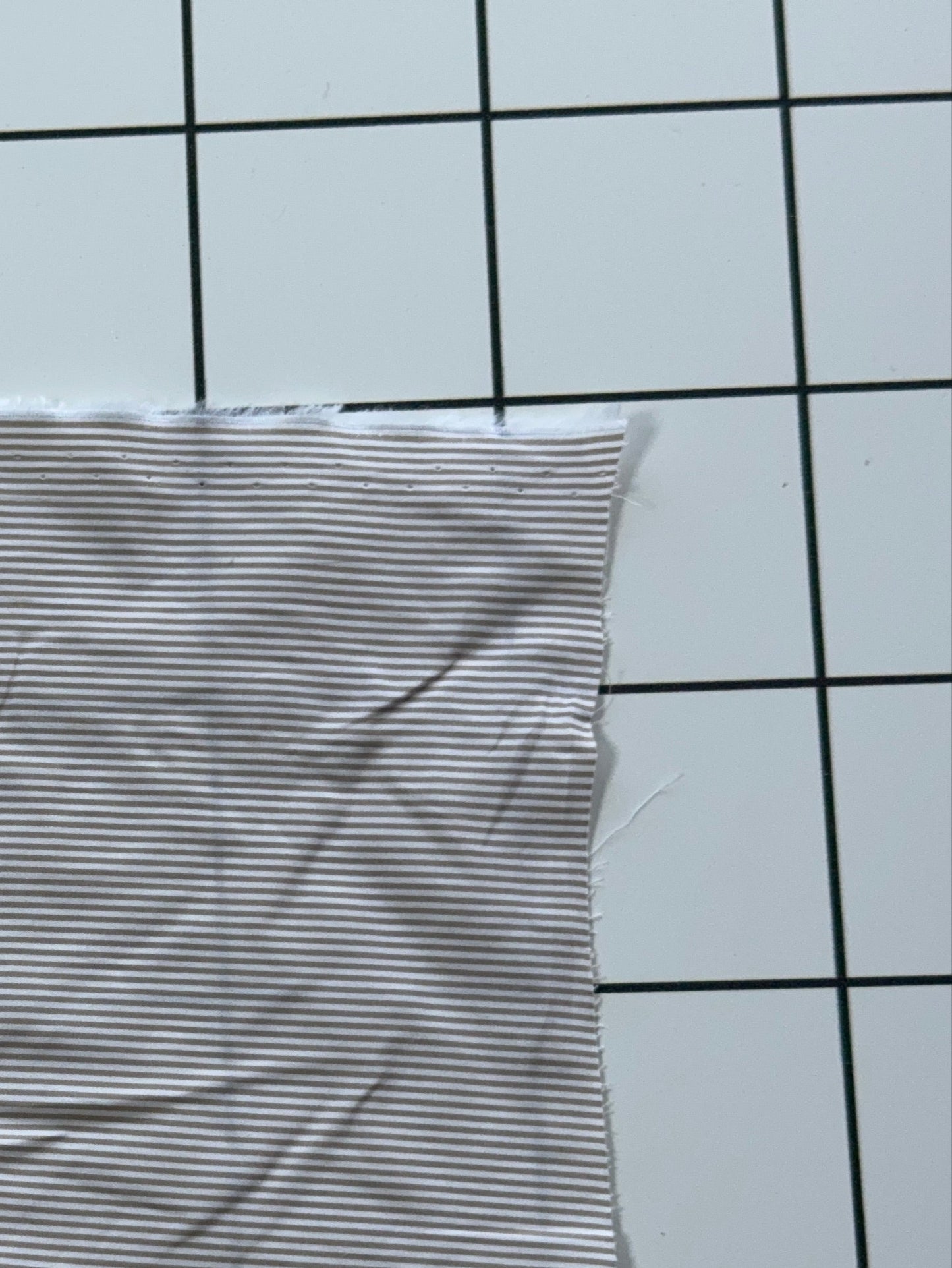 Striped fabric on a grid background