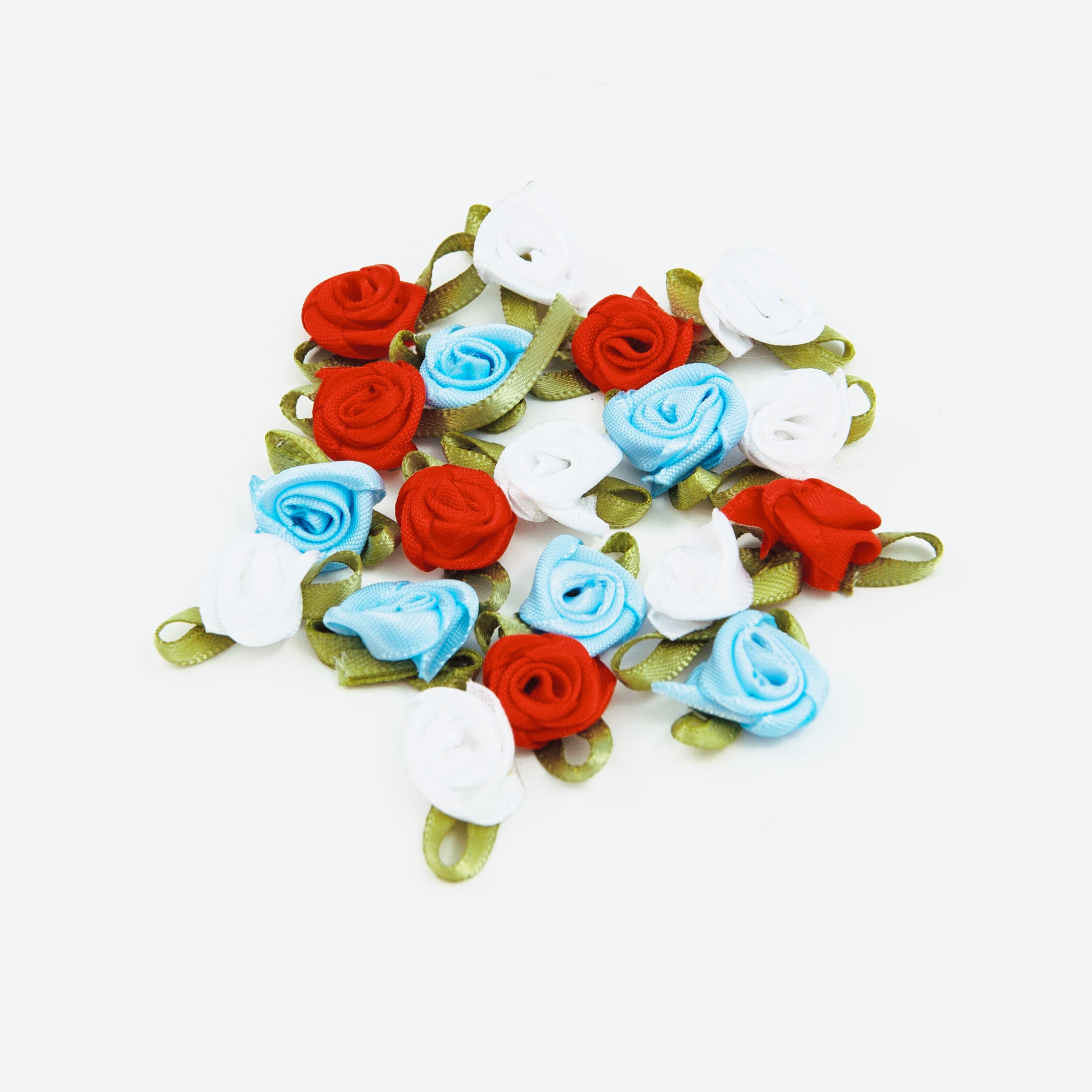 Heart-shaped arrangement of red, blue, and white flowers on a white background
