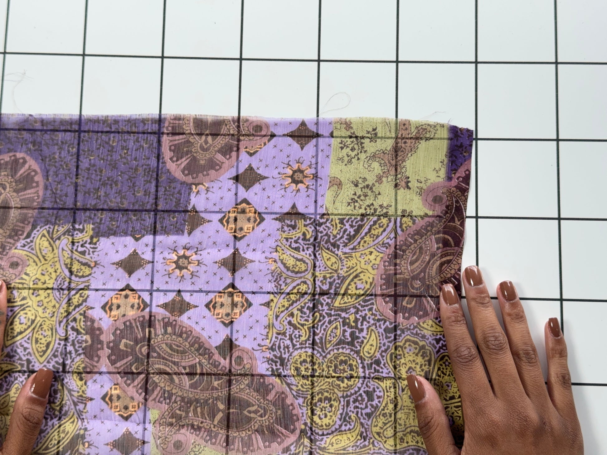 Patterned fabric on a white grid background