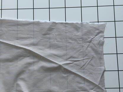 Striped fabric on a grid background