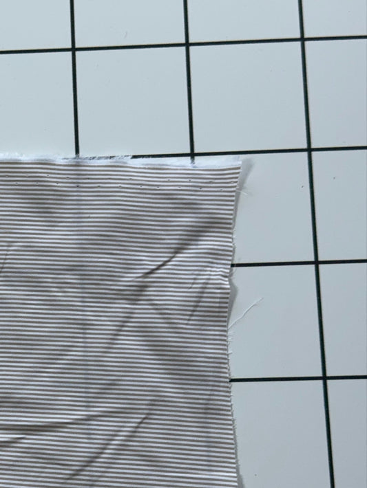 Striped fabric on a grid background