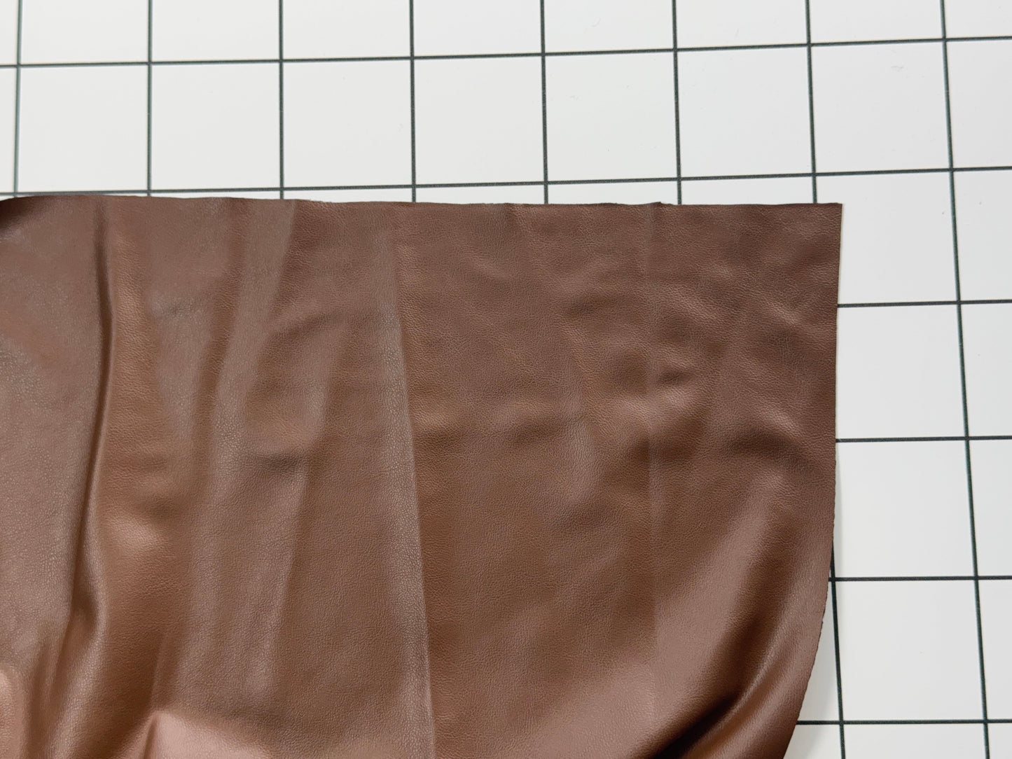 Brown fabric on a white grid background