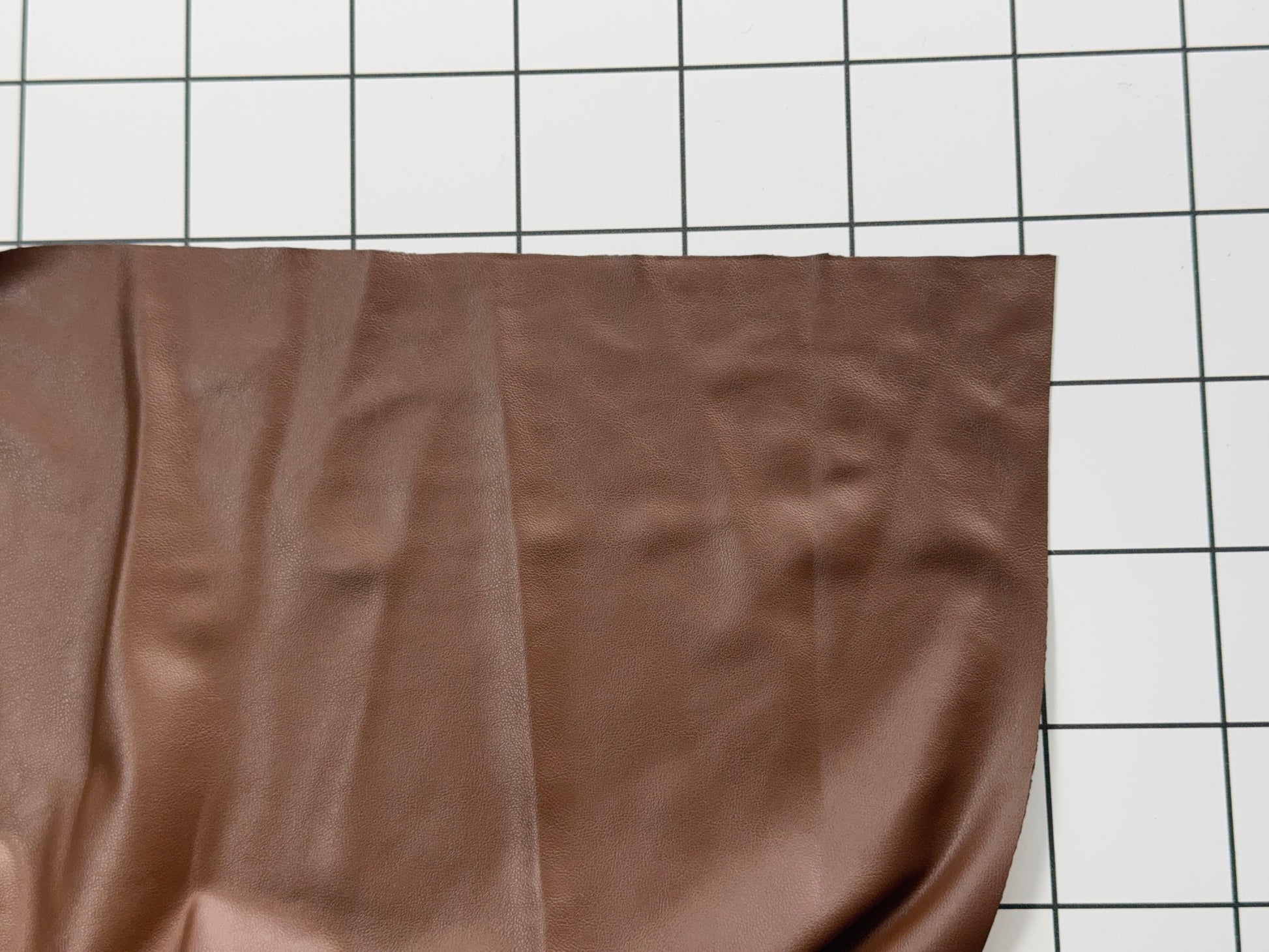 Brown fabric on a white grid background