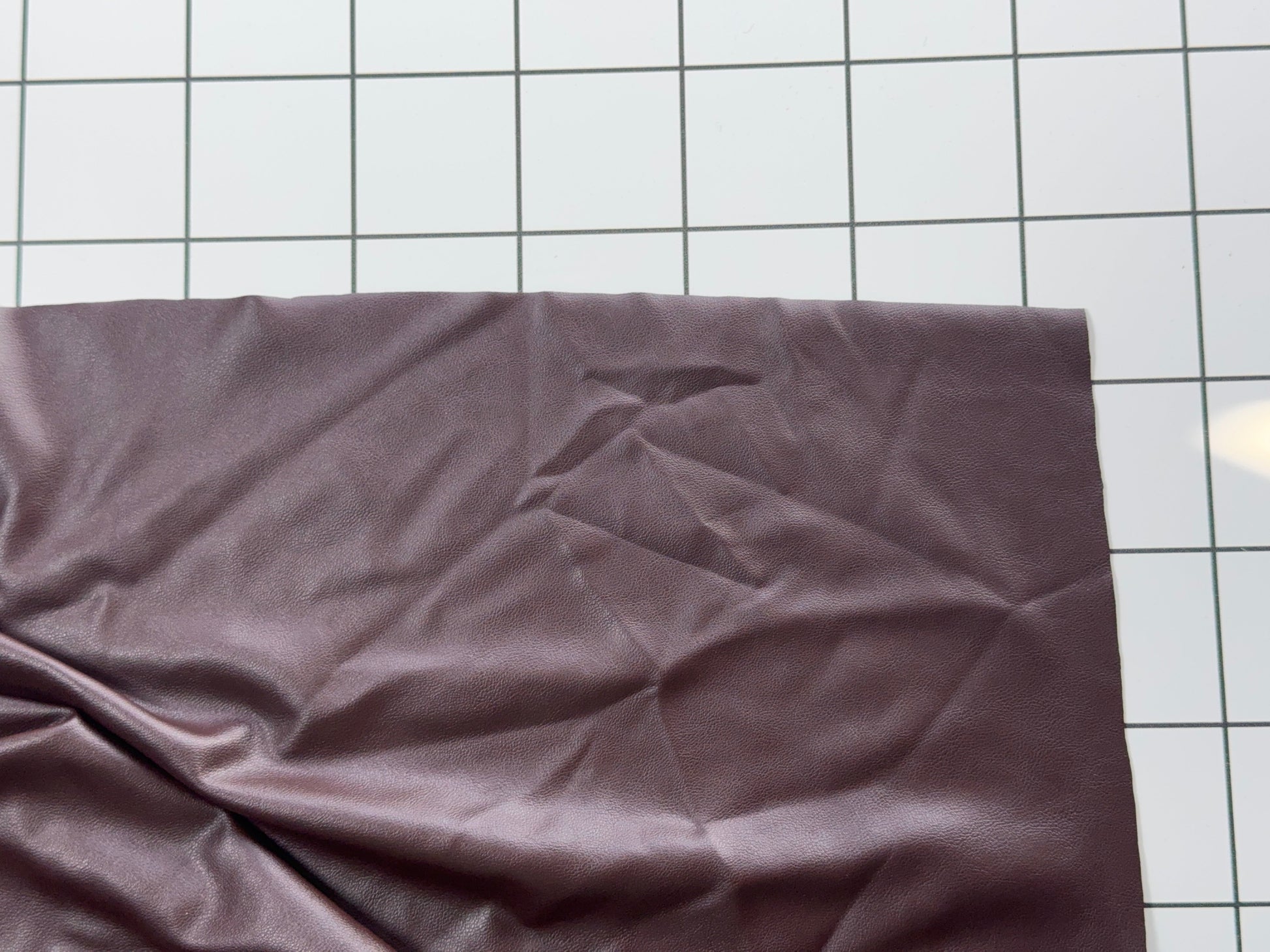 Plum Colored fabric on a white grid background