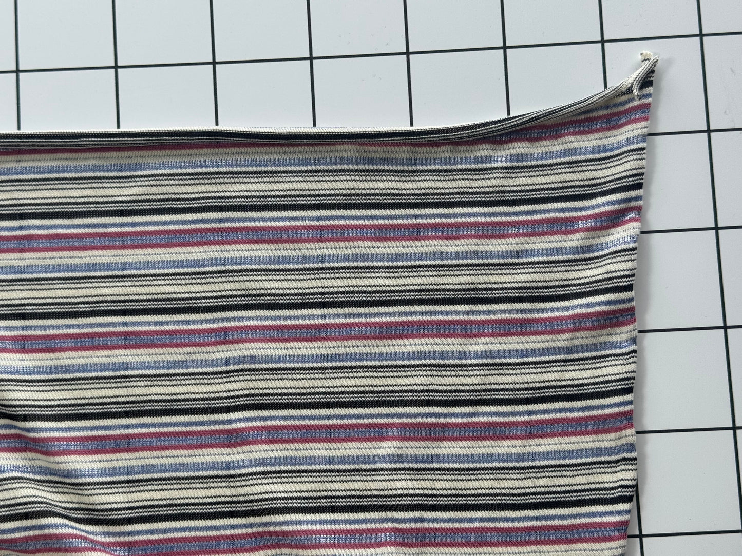 Striped fabric on a grid background