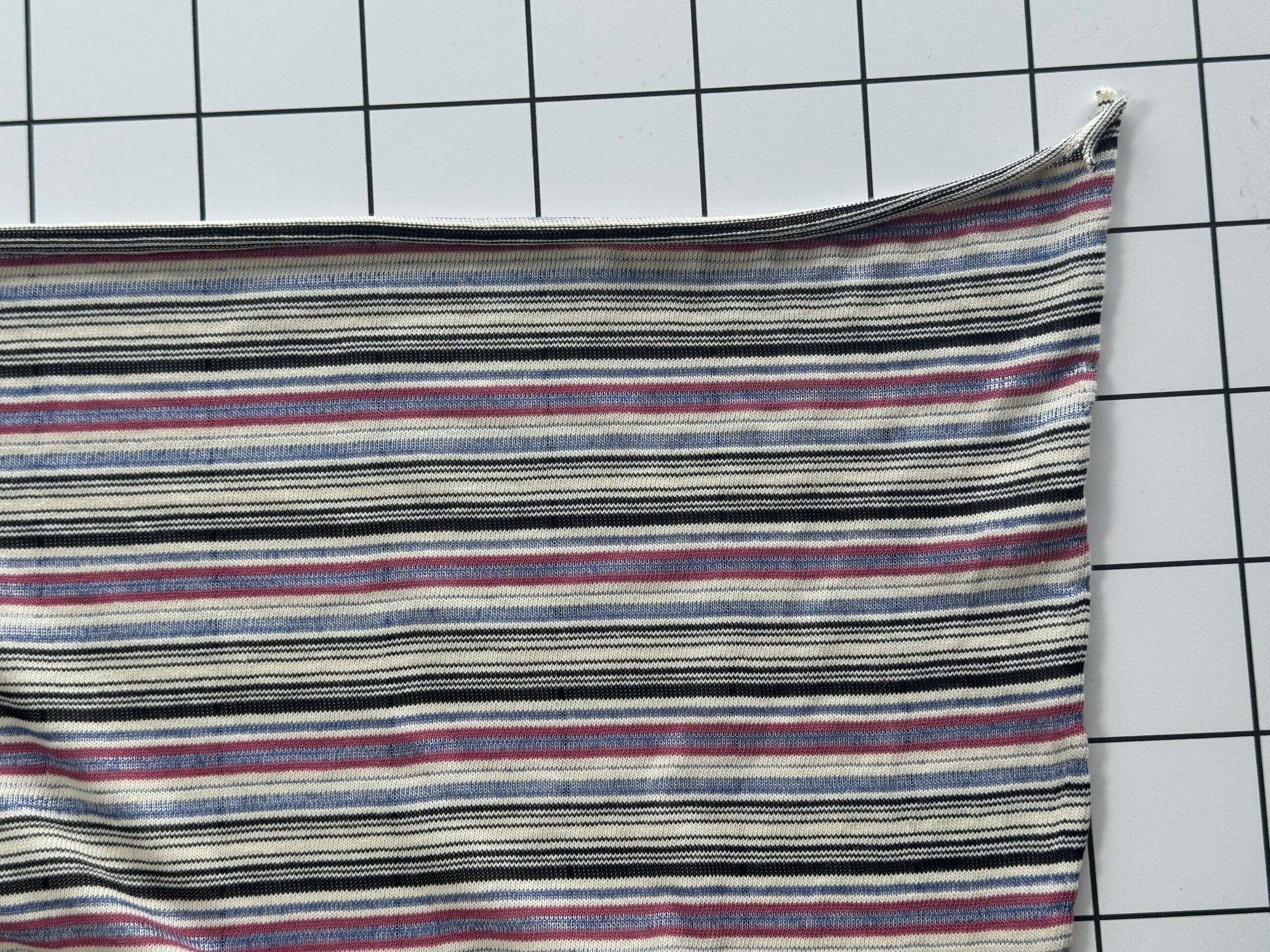 Striped fabric on a grid background
