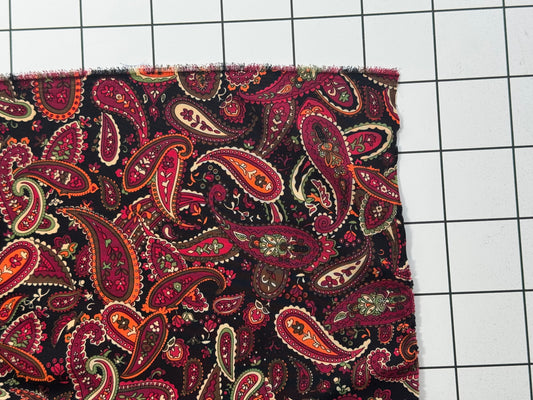 Paisley patterned fabric on a grid background