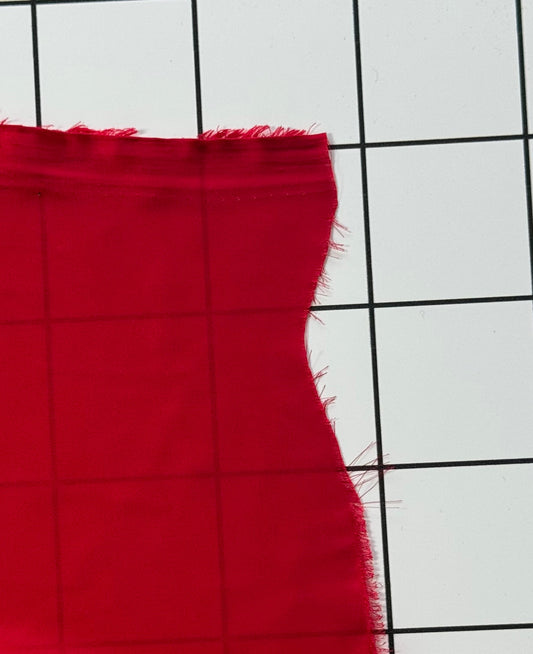Red fabric on a white grid background